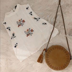 Both purse and embroidered shirt
